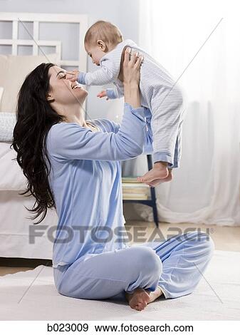 mother and baby in a bedroom View Large Photo Image Stock Photo - mother and baby in a bedroom. Fotosearch