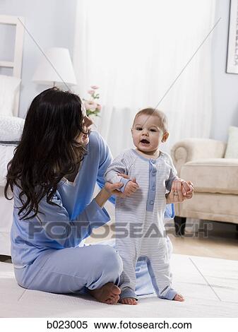 mother and baby in a bedroom View Large Photo Image Stock Photography - mother and baby in a bedroom. Fotosearch