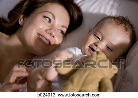 Stock Image - mother and baby in bed. Fotosearch