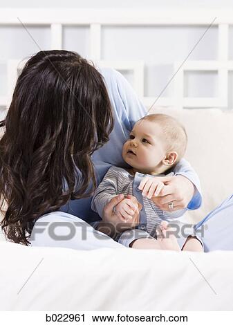 mother and baby on a bed View Large Photo Image Stock Image - mother and baby on a bed. Fotosearch