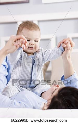 mother and baby on a bed View Large Photo Image Stock Image - mother and baby on a bed. Fotosearch