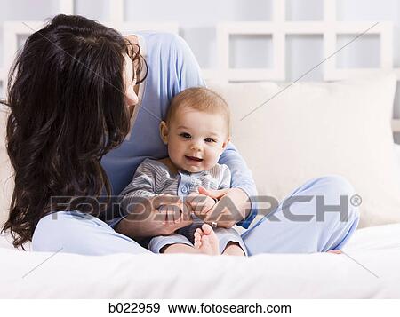 mother and baby on a bed View Large Photo Image Stock Photo - mother and baby on a bed. Fotosearch