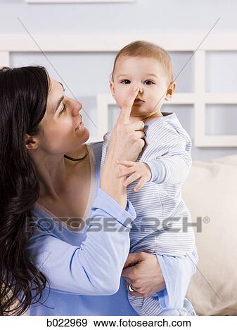 mother and baby on a bed View Large Photo Image Stock Photo - mother and baby on a bed. Fotosearch