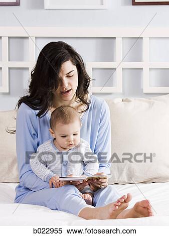 mother and baby on a bed View Large Photo Image Stock Photography - mother and baby on a bed. Fotosearch
