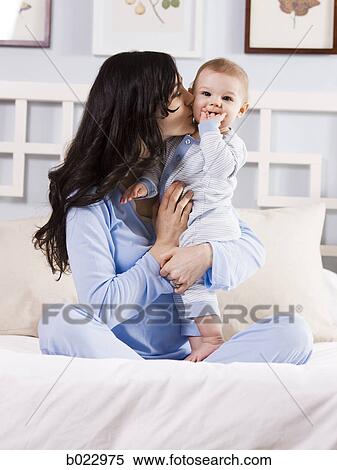 mother and baby on a bed View Large Photo Image Stock Photography - mother and baby on a bed. Fotosearch