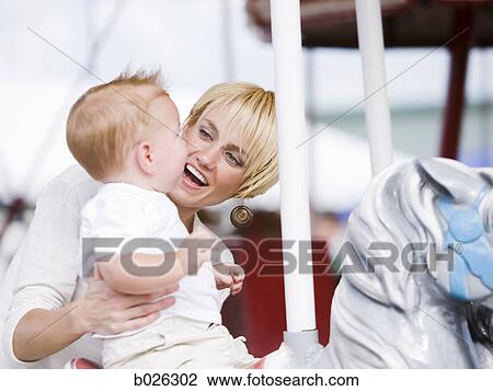 mother and baby on a merry-go-round View Large Photo Image Stock Image - mother and baby on a merry-go-round. Fotosearch