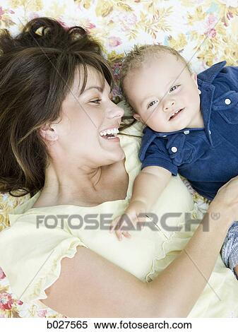mother and baby son in the garden lying on a blanket View Large Photo Image Stock Photography - mother and baby son in the garden lying on a blanket. Fotosearch