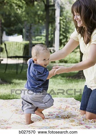 Stock Image - mother and baby son in the garden. Fotosearch