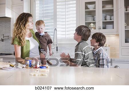 Stock Photo - mother and children in the kitchen. Fotosearch