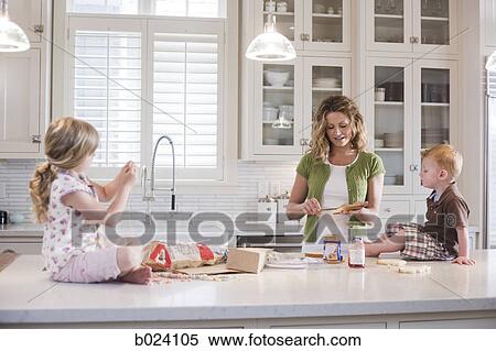 Stock Photography - mother and children in the kitchen. Fotosearch