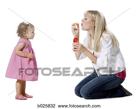 mother and daughter blowing bubbles View Large Photo Image Stock Image - mother and daughter blowing bubbles. Fotosearch