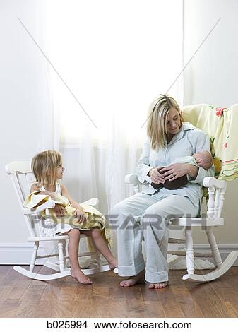 mother and daughter each holding a newborn baby View Large Photo Image Picture - mother and daughter each holding a newborn baby. Fotosearch
