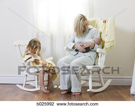 mother and daughter each holding a newborn baby View Large Photo Image Stock Image - mother and daughter each holding a newborn baby. Fotosearch