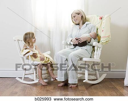 mother and daughter each holding a newborn baby View Large Photo Image Stock Image - mother and daughter each holding a newborn baby. Fotosearch