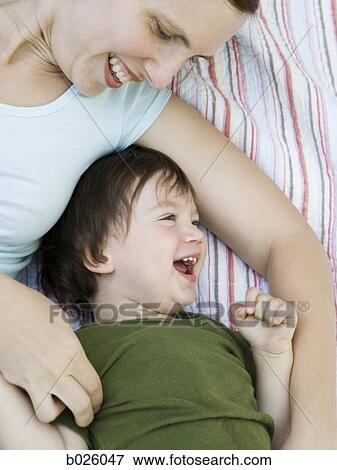 mother and son lying down View Large Photo Image Stock Photo - mother and son lying down. Fotosearch