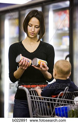mother comparing juices at supermarket View Large Photo Image Stock Image - mother comparing juices at supermarket. Fotosearch