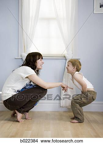mother dressing her son View Large Photo Image Picture - mother dressing her son. Fotosearch