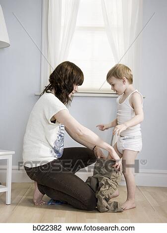 mother dressing her son View Large Photo Image Stock Image - mother dressing her son. Fotosearch