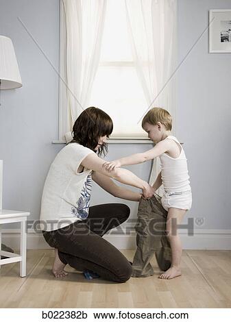 mother dressing her son View Large Photo Image Stock Image - mother dressing her son. Fotosearch