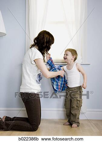 mother dressing her son View Large Photo Image Stock Image - mother dressing her son. Fotosearch