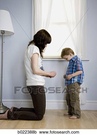 mother dressing her son View Large Photo Image Stock Image - mother dressing her son. Fotosearch