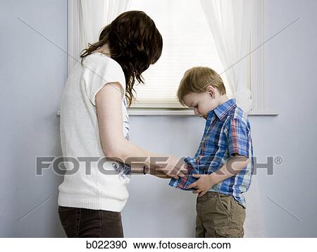 mother dressing her son View Large Photo Image Stock Image - mother dressing her son. Fotosearch