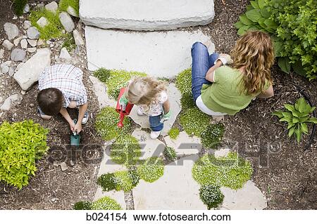 mother gardening with son and daughter View Large Photo Image Picture - mother gardening with son and daughter. Fotosearch