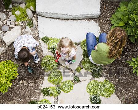 mother gardening with son and daughter View Large Photo Image Stock Image - mother gardening with son and daughter. Fotosearch