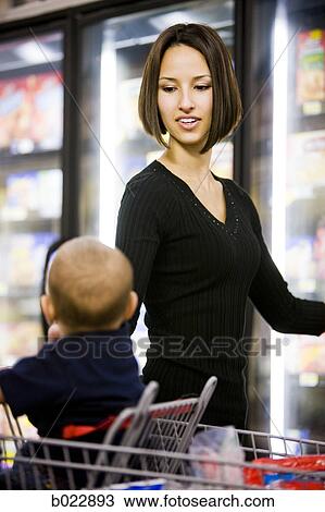 mother grocery shopping with baby View Large Photo Image Stock Image - mother grocery shopping with baby. Fotosearch
