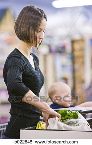 mother grocery shopping with baby View Large Photo Image Stock Photography - mother grocery shopping with baby. Fotosearch