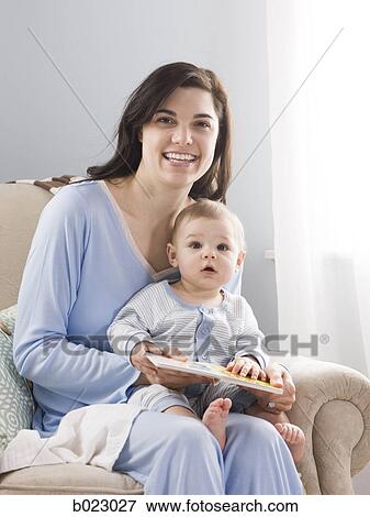mother reading a book to her baby View Large Photo Image Stock Photo - mother reading a book to her baby. Fotosearch