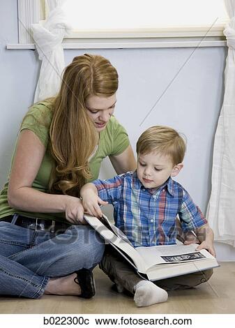 Stock Image - mother reading with child. Fotosearch