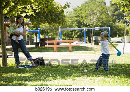 mother watching son play with toy golf club View Large Photo Image Stock Photography - mother watching son play with toy golf club. Fotosearch