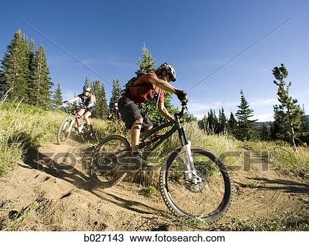 mountain bikers riding down a trail View Large Photo Image Stock Image - mountain bikers riding down a trail. Fotosearch