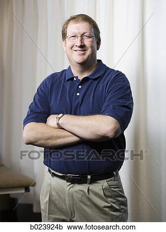 physical therapist standing with arms folded View Large Photo Image Stock Image - physical therapist standing with arms folded. Fotosearch