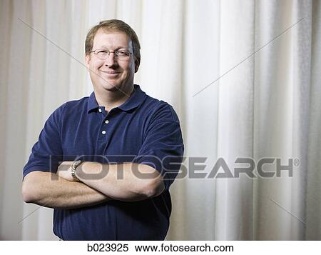 Stock Photography - physical therapist standing with arms folded. Fotosearch