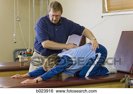 Stock Photograph - physical therapist working with a woman. Fotosearch