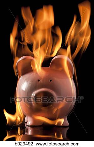 Stock Image - piggybank on fire. Fotosearch