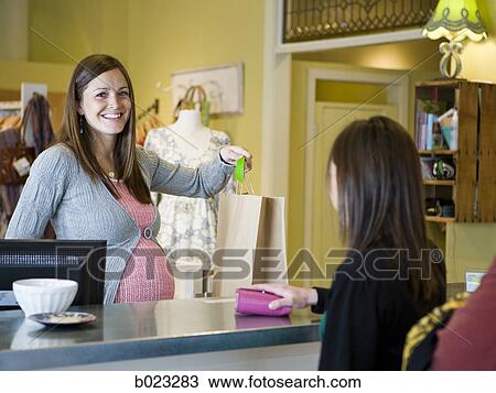 pregnant clothing store clerk View Large Photo Image Stock Image - pregnant clothing store clerk. Fotosearch