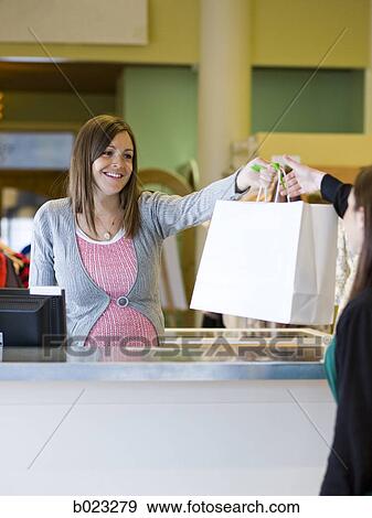 pregnant clothing store clerk View Large Photo Image Stock Photo - pregnant clothing store clerk. Fotosearch