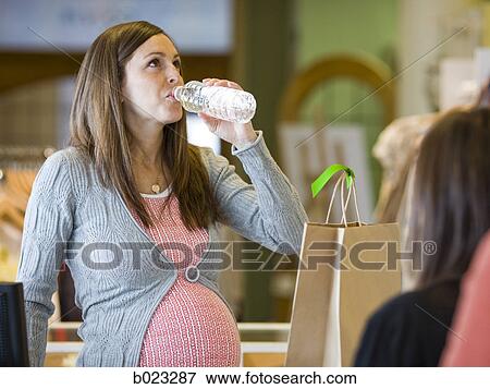 pregnant clothing store clerk View Large Photo Image Stock Photo - pregnant clothing store clerk. Fotosearch