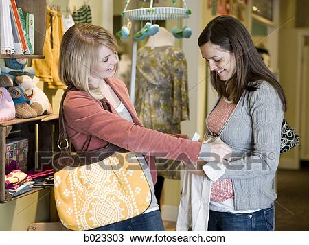 pregnant woman and a friend shopping for clothes View Large Photo Image Stock Image - pregnant woman and a friend shopping for clothes. Fotosearch