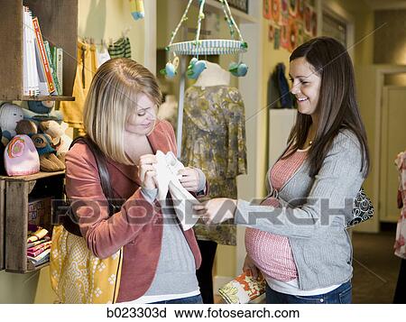 pregnant woman and a friend shopping for clothes View Large Photo Image Stock Image - pregnant woman and a friend shopping for clothes. Fotosearch