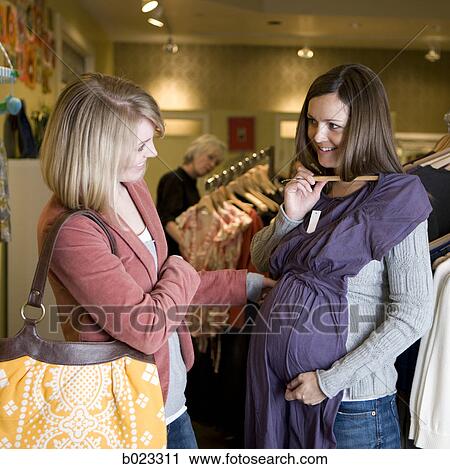 pregnant woman and a friend shopping for clothes View Large Photo Image Stock Image - pregnant woman and a friend shopping for clothes. Fotosearch