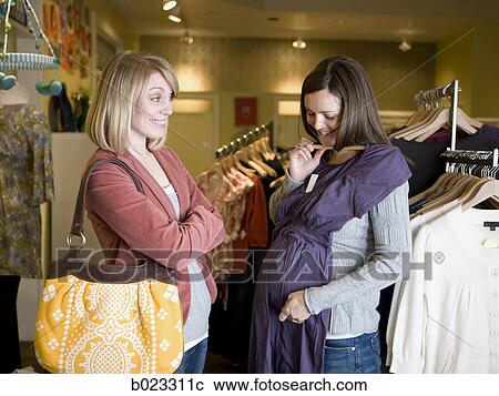 pregnant woman and a friend shopping for clothes View Large Photo Image Stock Image - pregnant woman and a friend shopping for clothes. Fotosearch