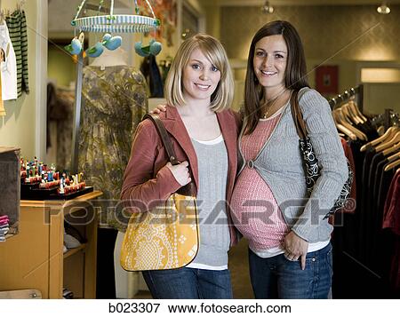 pregnant woman and a friend shopping for clothes View Large Photo Image Stock Photo - pregnant woman and a friend shopping for clothes. Fotosearch
