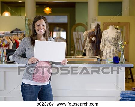 pregnant woman holding up a sign View Large Photo Image Stock Photo - pregnant woman holding up a sign. Fotosearch