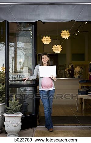 pregnant woman holding up a sign View Large Photo Image Stock Photo - pregnant woman holding up a sign. Fotosearch