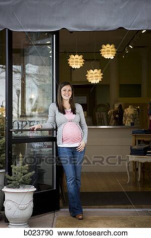 pregnant woman in front of a store View Large Photo Image Stock Image - pregnant woman in front of a store. Fotosearch