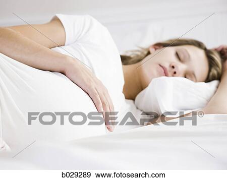 Stock Photo - pregnant woman sleeping. Fotosearch